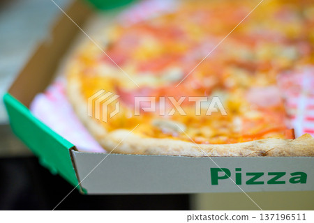 Pizza in open delivery box close-up Pizza in open delivery box close-up 137196511
