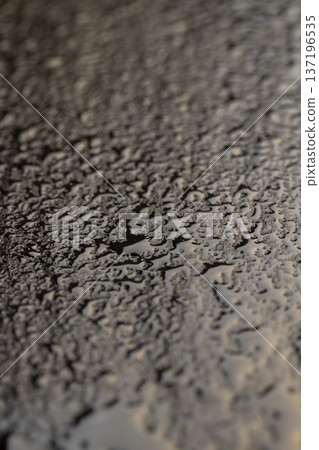 wet black uneven and embossed black slate for serving, covered with lots of drops kitchen board made of black embossed slate wet black uneven and embossed black slate for serving, covered with lots of drops kitchen board made of black embossed slate 137196535