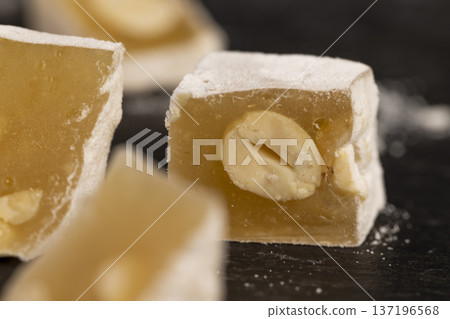soft and fresh Turkish delight with powdered white sugar, diced sweet white soft Turkish delight slices with nuts and dried fruits, cut into pieces 137196568