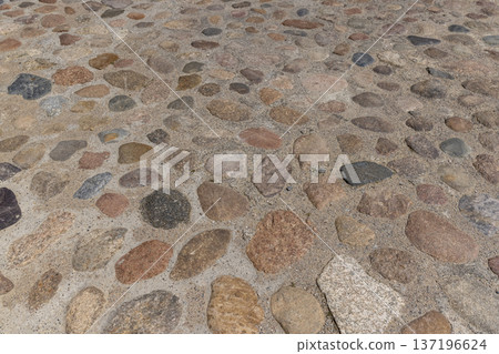 a road made of stones of different sizes in rural areas, a reconstructed ancient road made of multicolored stones, cobblestones and pebbles a road made of stones of different sizes in rural areas, a reconstructed ancient road made of multicolored stones, cobblestones and pebbles 137196624