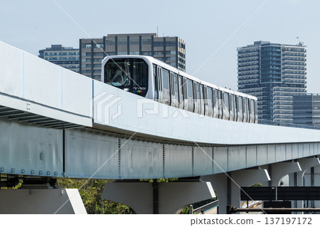 View of a New Transit Yurikamome line train running on the elevated track in Koto, Tokyo, Japan. It's an automated guideway transit service in Tokyo. View of a New Transit Yurikamome line train running on the elevated track in Koto, Tokyo, Japan. It's an automated guideway transit service in Tokyo. 137197172