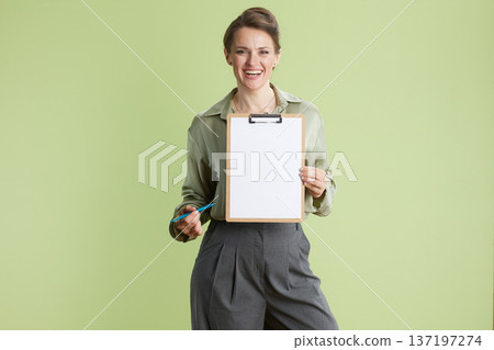 Smiling professional presenting blank clipboard 137197274
