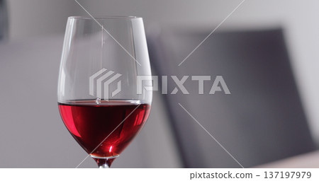 red wine into wineglass dining room on background red wine into wineglass dining room on background 137197979