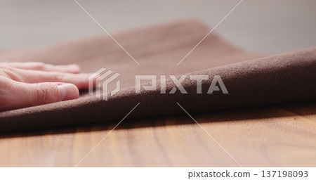 man hand checking brown leather piece closeup man hand checking brown leather piece closeup 137198093