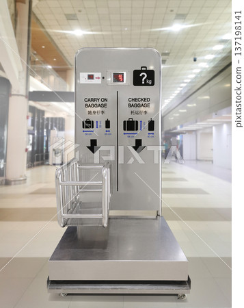 Baggage size and weight checking machine located in the airport terminal before boarding. Baggage size and weight checking machine located in the airport terminal before boarding. 137198141
