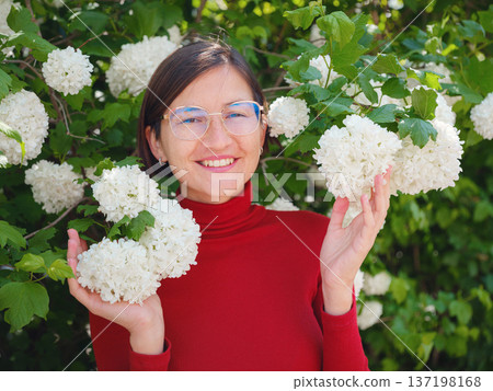 Woman in glasses stands in center of Frankfurt, 137198168