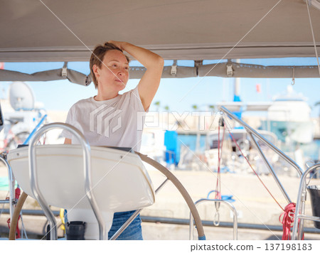 Woman Captain Steering Yacht Wheel Maneuvering From Marina Woman Captain Steering Yacht Wheel Maneuvering From Marina 137198183