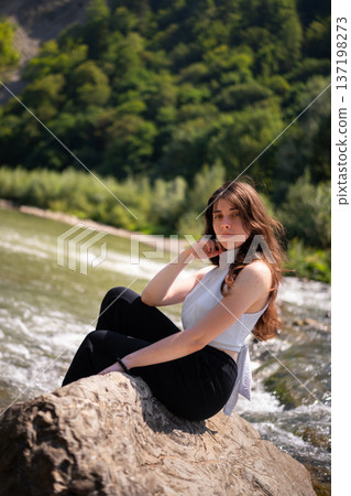 Natural Portrait of a Young Woman by a Mountain River Natural Portrait of a Young Woman by a Mountain River 137198273