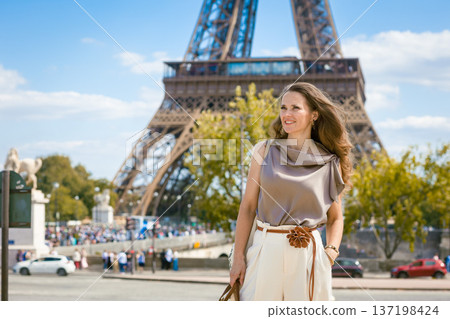 Stylish Traveler Poses by the Eiffel Tower in Paris Stylish Traveler Poses by the Eiffel Tower in Paris 137198424