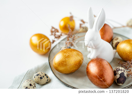 Golden and bronze Easter eggs and Easter bunny 137201820