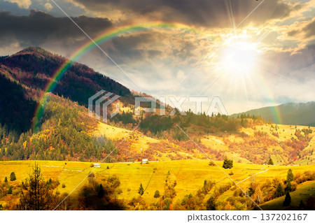 autumn landscape of rural region in mountains at sunset. rolling hills with green alps in dappled evening light. serene countryside under cloudy sky. timeless nostalgia book cover with rainbow autumn landscape of rural region in mountains at sunset. rolling hills with green alps in dappled evening light. serene countryside under cloudy sky. timeless nostalgia book cover with rainbow 137202167