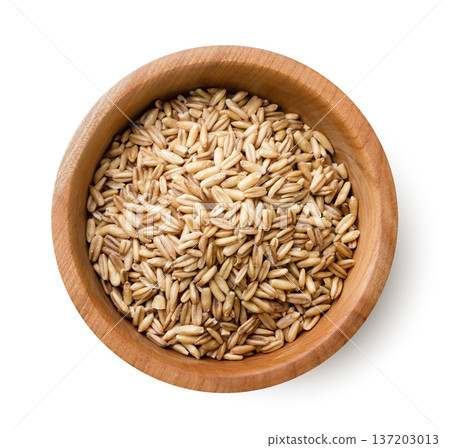 Raw oat grains in a wooden plate on a white background. Top view Raw oat grains in a wooden plate on a white background. Top view 137203013