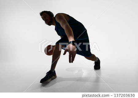 Basketball player in dynamic dribble wearing smartwatch in studio Basketball player in dynamic dribble wearing smartwatch in studio 137203630