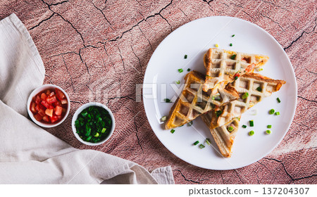 Bacon, cheese and tomatoes baked in waffle bread on a plate on the table top view web banner Bacon, cheese and tomatoes baked in waffle bread on a plate on the table top view web banner 137204307