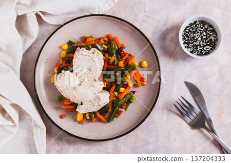 Boiled chicken fillet and mixed vegetables on a plate on the table top view Boiled chicken fillet and mixed vegetables on a plate on the table top view 137204333