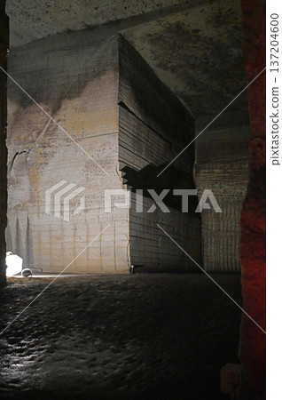 Huge stone pillars towering over the abyss and silent underground ruins Huge stone pillars towering over the abyss and silent underground ruins 137204600