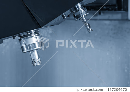 Close-up of an indexable face milling tool with carbide inserts installed in a CNC machining center's automatic tool changer (ATC) magazine. Close-up of an indexable face milling tool with carbide inserts installed in a CNC machining center's automatic tool changer (ATC) magazine. 137204670