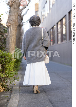 Rear view of a senior woman walking in the city Rear view of a senior woman walking in the city 137205168