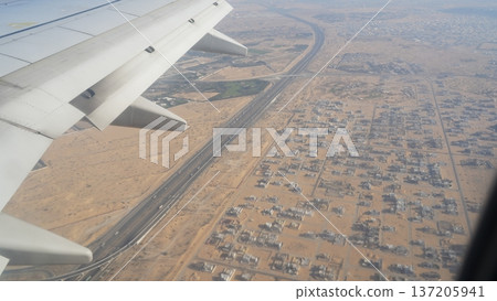 Aerial view of desert landscape with highway and residential areas 137205941