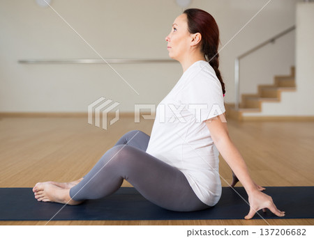 Pregnant woman is engaged in yoga. Butterfly Pose or Baddha Konasana 137206682