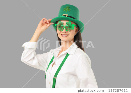 A woman wears a green hat and shamrock glasses for St. Patrick's Day A woman wears a green hat and shamrock glasses for St. Patrick's Day 137207611