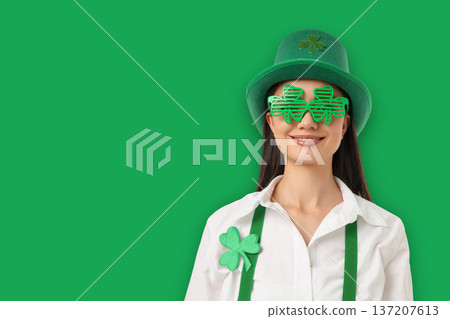 A woman with a smile wears a green costume and festive glasses A woman with a smile wears a green costume and festive glasses 137207613