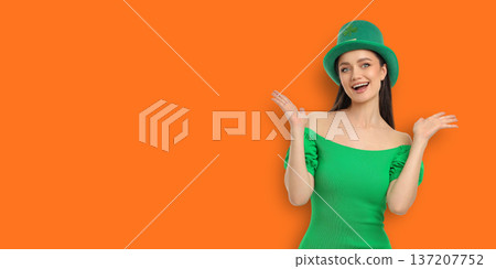Girl wears green dress and hat while celebrating St. Patrick's Day Girl wears green dress and hat while celebrating St. Patrick's Day 137207752