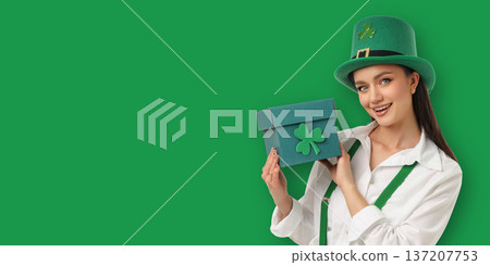A young woman holds a green box while wearing a costume 137207753