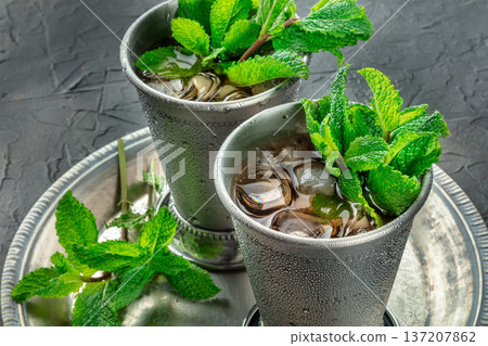 Mint Julep cocktail in the Kentucky Derby classic silver glass, with fresh mint 137207862