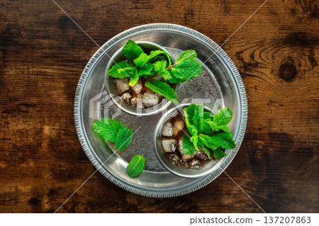 Mint Julep in the Kentucky Derby classic silver glass, with fresh mint leaves Mint Julep in the Kentucky Derby classic silver glass, with fresh mint leaves 137207863
