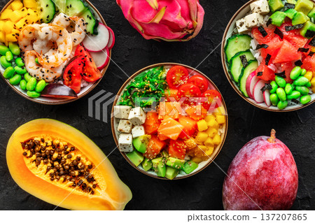 Poke bowl assortment. Rice with salmon, shrimps, and grapefruit, overhead shot Poke bowl assortment. Rice with salmon, shrimps, and grapefruit, overhead shot 137207865