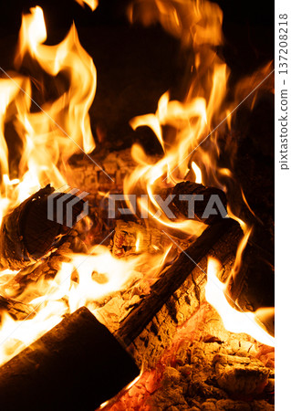 Close-up of Logs Burning with Intense Yellow and Orange Flames. Close-up of Logs Burning with Intense Yellow and Orange Flames. 137208218