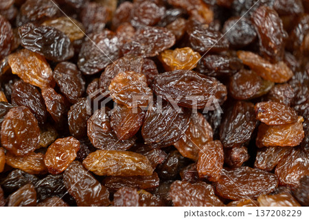 Macro texture of brown raisins, food background. Macro texture of brown raisins, food background. 137208229
