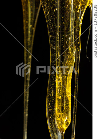 Abstract macro of thick golden honey texture. Abstract macro of thick golden honey texture. 137208239