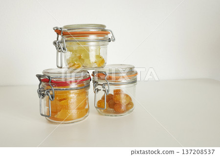 Preparing candied citrus fruits for jars. Sweets and traditional food in Italy. Kumquats, orange peels, and citron. Seasonal, high-quality European farm products. 137208537