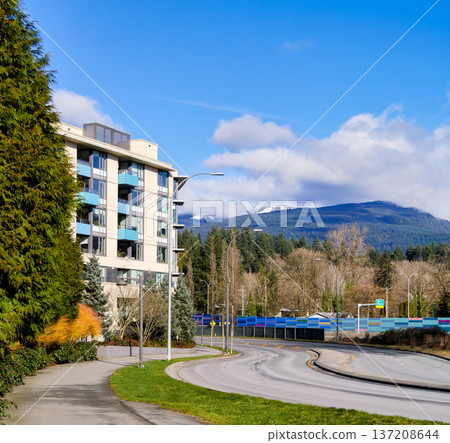 Cityscape with residential building and road curve around on blue sky background 137208644