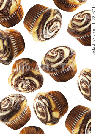 Delicious chocolate marble muffins in scattered layout, isolated on white background. Concept of sweet bakery treats 137208712
