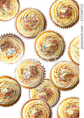 Vanilla cupcakes with creamy frosting and colorful sprinkles, isolated on white background. Concept of sweet dessert treats 137208722