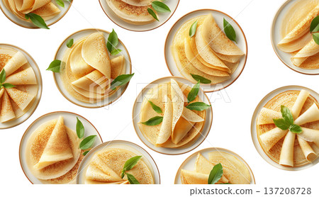 Multiple plates of folded golden crepes decorated with green leaves, top view isolated on white background, concept of food presentation 137208728