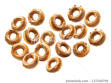Multiple caramel glazed donuts scattered in a seamless pattern, isolated on white background, concept of dessert 137208740