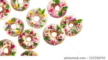 Decorative donuts topped with edible flowers, mint, and icing, isolated on white background, concept of floral dessert Decorative donuts topped with edible flowers, mint, and icing, isolated on white background, concept of floral dessert 137208745