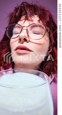 Red haired woman with glasses enjoying beer close up portrait. 137210330