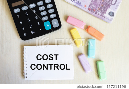 The concept of cost control is a text on a notepad, next to euro banknotes and a calculator The concept of cost control is a text on a notepad, next to euro banknotes and a calculator 137211196