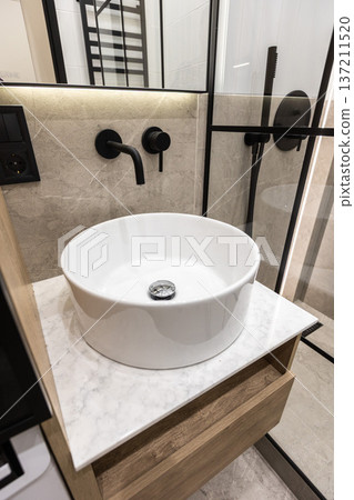 Modern bathroom sink with black wall faucet Modern bathroom sink with black wall faucet 137211520