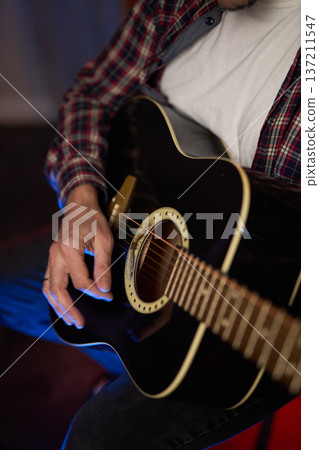 Close-Up of Guitarist Playing Acoustic Guitar Close-Up of Guitarist Playing Acoustic Guitar 137211547