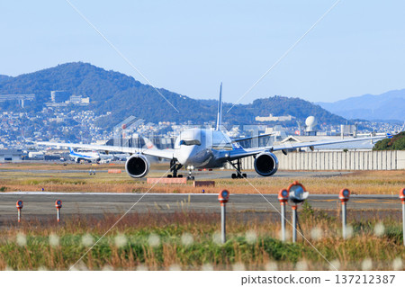 Aircraft taking off from the runway at Osaka International Airport (Itami Airport) Aircraft taking off from the runway at Osaka International Airport (Itami Airport) 137212387
