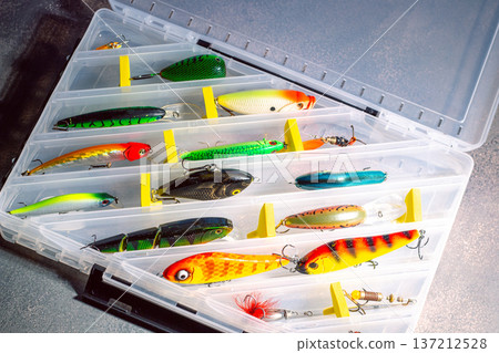 Large fisherman tackle box fully stocked with lures and gear for fishing. Kit of lures and fishing accessories Large fisherman tackle box fully stocked with lures and gear for fishing. Kit of lures and fishing accessories 137212528