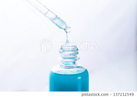 Blue Copper peptides skin repairing serum in transparent bottle. Face and skin beauty routine themes 137212549