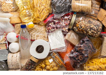 Essential home food stock for military operations and crises and for the period of quarantine and isolation, canned food, pasta, flour and nonperishable items,the concept of stay at home Essential home food stock for military operations and crises and for the period of quarantine and isolation, canned food, pasta, flour and nonperishable items,the concept of stay at home 137213162