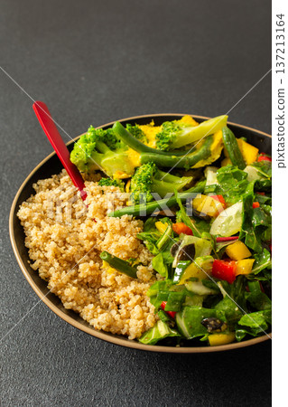 This healthy breakfast consists of a quinoa bowl served with boiled eggs, green beans, and broccoli, alongside a fresh salad. It offers a nutritious start to the day This healthy breakfast consists of a quinoa bowl served with boiled eggs, green beans, and broccoli, alongside a fresh salad. It offers a nutritious start to the day 137213164